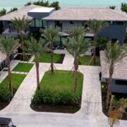 Aerial view of a coastal luxury residence with smart home automation, security, lighting, and integrated technology by Sound & Vision Technology