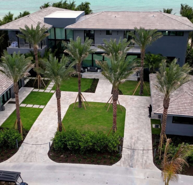 Aerial view of a coastal luxury residence with smart home automation, security, lighting, and integrated technology by Sound & Vision Technology