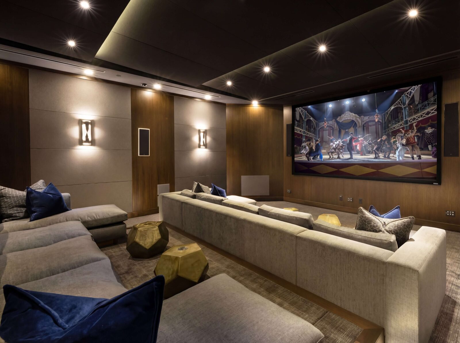 Luxury home theater with large projection screen, integrated audio, architectural lighting, and custom entertainment technology by Sound & Vision Technology