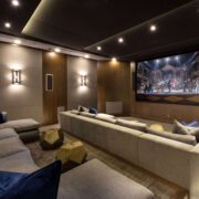 Luxury home theater with large projection screen, integrated audio, architectural lighting, and custom entertainment technology by Sound & Vision Technology