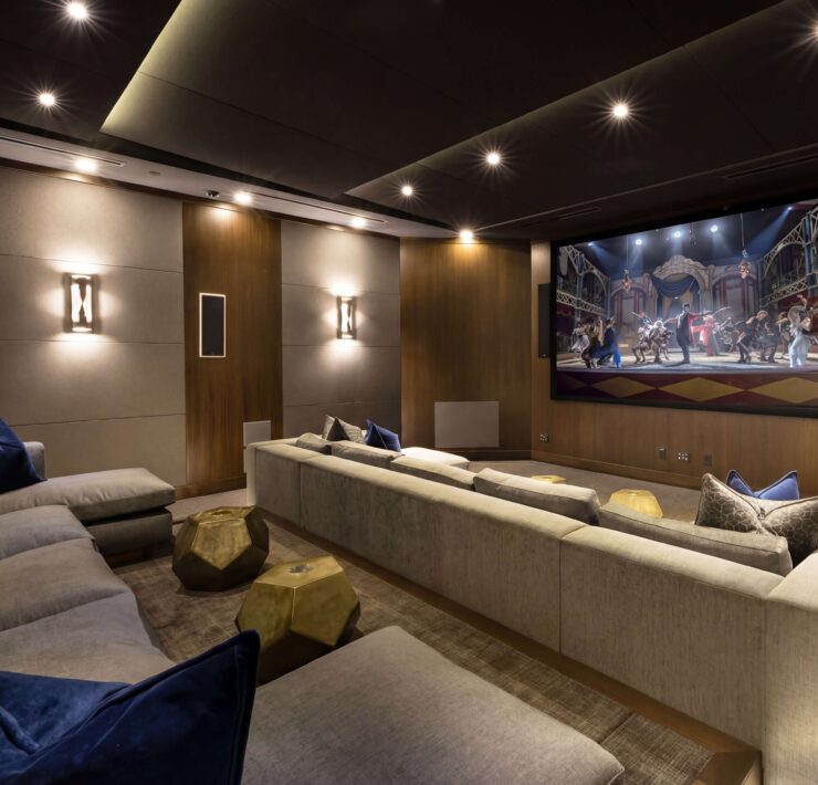 Luxury home theater with large projection screen, integrated audio, architectural lighting, and custom entertainment technology by Sound & Vision Technology