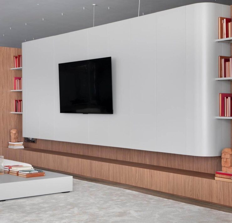 Florense Moderna Home living room wall system with white cabinetry, wood paneling, built-in shelving, and modern media storage.