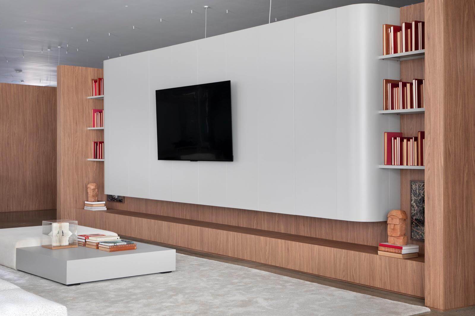 Florense Moderna Home living room wall system with white cabinetry, wood paneling, built-in shelving, and modern media storage.
