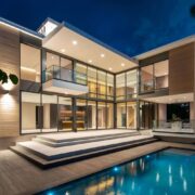 Trazzo modern waterfront residence lighting with illuminated exterior, pool lighting, glass walls, and luxury architectural lighting design.