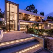 Trazzo contemporary exterior landscape lighting with illuminated steps, facade lighting, garden accents, and modern residential architecture.