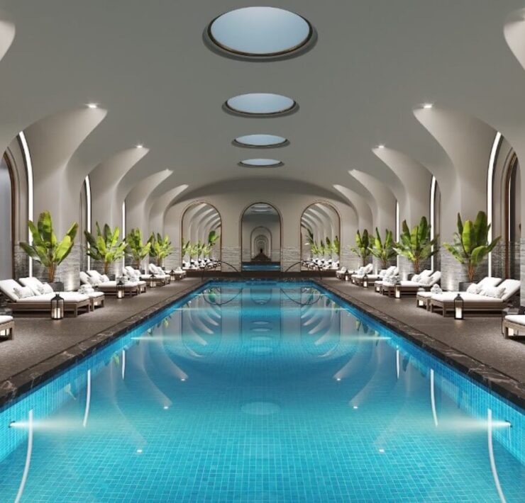 Trazzo luxury pool and spa lighting design with illuminated arches, underwater pool lights, lounge areas, and hospitality-style ambiance.