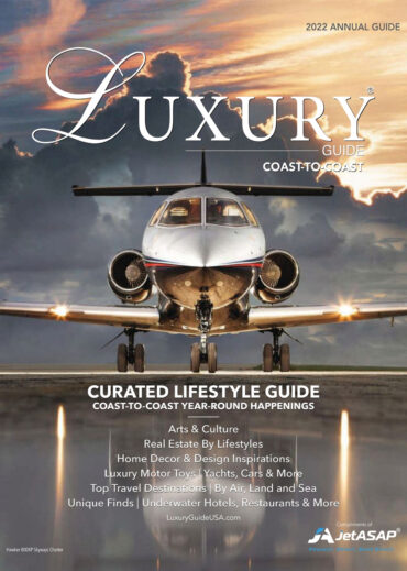 2022 Luxury Guide Cover National Luxury Guide 2022 Annual Guide cover featuring a private jet on a runway beneath a dramatic sunset sky.