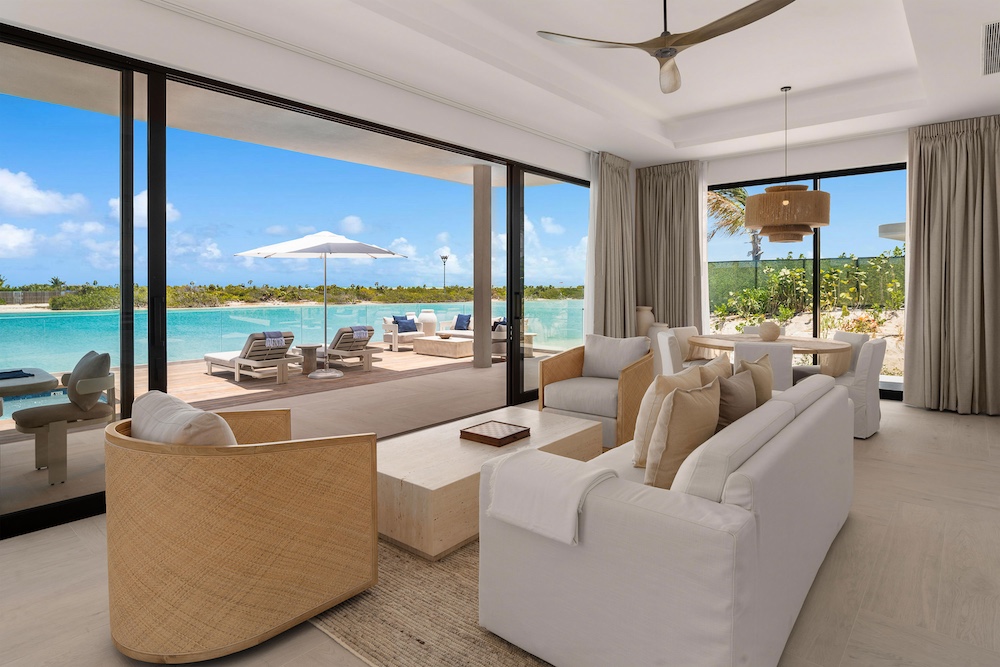 Waterside bungalow living room with private pool at Ambergris Cay, Turks and Caicos