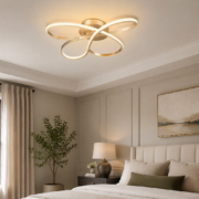 Minka Astor LED flush mount light fixture above a neutral bedroom with soft bedding, wall paneling, and natural light.