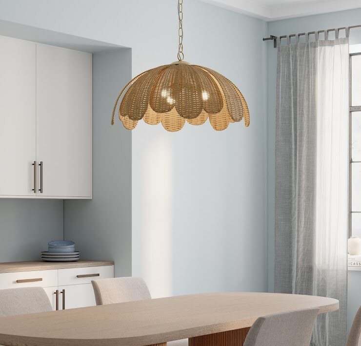 Minka Covea pendant with rattan shade above a modern dining table in a soft blue room with neutral chairs and sheer curtains.