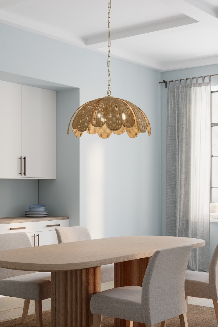 Minka Covea pendant with rattan shade above a modern dining table in a soft blue room with neutral chairs and sheer curtains.