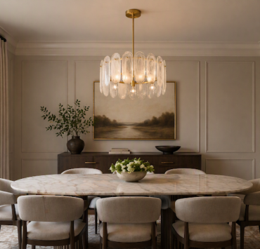 Minka Oldmill glass chandelier above an oval marble dining table with upholstered chairs, wall paneling, and soft neutral décor.