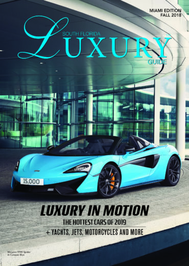 Luxury Guide Cover Fall 2018 South Florida Luxury Guide Miami Fall 2018 cover featuring a turquoise McLaren 570S Spider parked outside a modern glass building.