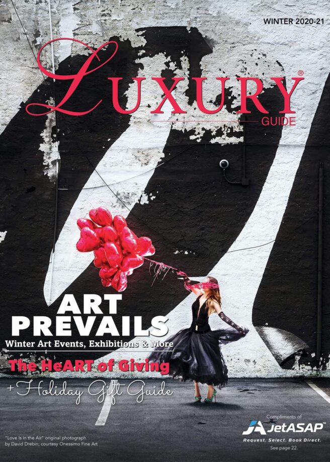 Luxury Guide Cover Winter 20_21 Luxury Guide Winter 2020–21 cover featuring a woman in a black dress holding red heart-shaped balloons before a bold black-and-white mural.