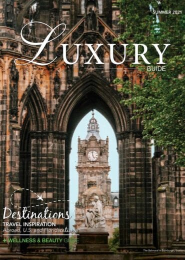 Luxury Guide Summer 2021 Luxury Guide Summer 2021 cover featuring Edinburgh’s historic Gothic architecture, with the Balmoral Hotel clock tower framed through a stone archway.